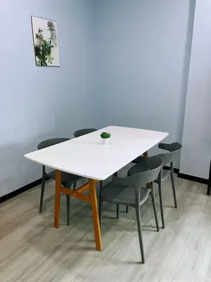a white table and chairs with a plant on it at Good Night BD Motel -PEKAN BAGAN DATUK-SELF CHECK IN in Bagan Datuk