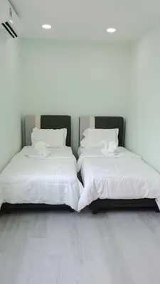 two beds sitting next to each other in a room at Good Night BD Motel -PEKAN BAGAN DATUK-SELF CHECK IN in Bagan Datuk