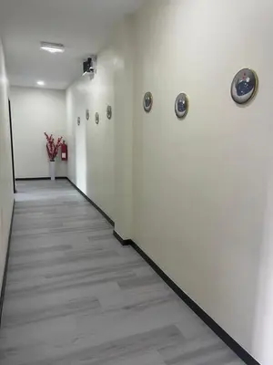 a hallway with white walls and a wooden floor at Good Night BD Motel -PEKAN BAGAN DATUK-SELF CHECK IN in Bagan Datuk