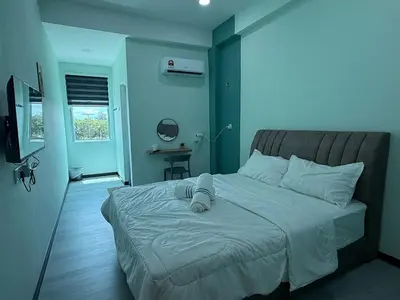 a bedroom with a large bed with blue walls at Good Night BD Motel -PEKAN BAGAN DATUK-SELF CHECK IN in Bagan Datuk