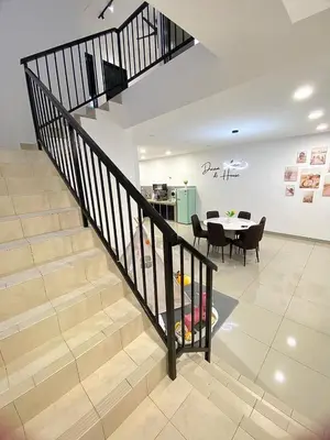 a staircase in a house with a table and a dining room at Cloud Nine Homestay in Taiping