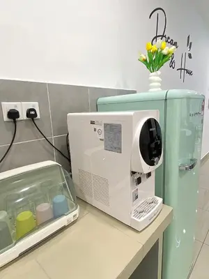 a microwave sitting on top of a counter in a room at Cloud Nine Homestay in Taiping