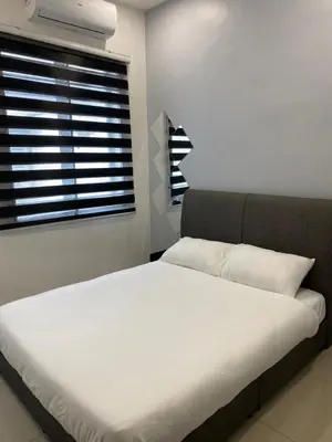 a bedroom with a white bed and a window at Cloud Nine Homestay in Taiping