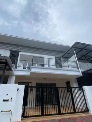 a house with a balcony and a gate at Cloud Nine Homestay in Taiping