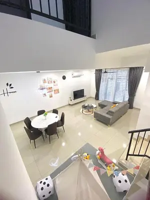a living room with a table and a couch at Cloud Nine Homestay in Taiping