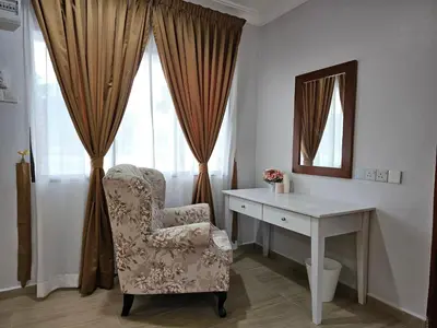 a room with a desk and a chair and a mirror at Cottage Inn Gerik in Gerik