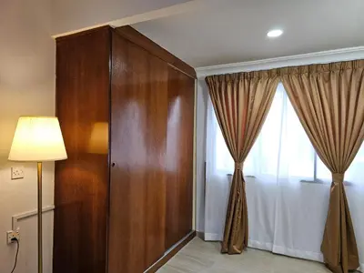 a room with a large wooden door and a window at Cottage Inn Gerik in Gerik