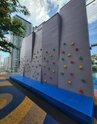 a wall with a climbing wall with umbrellas on it at Urban Suites, Best Seaview and Cityview in Town in Jelutong