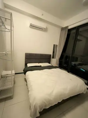 a bedroom with a large bed with a window at Urban Suites, Best Seaview and Cityview in Town in Jelutong