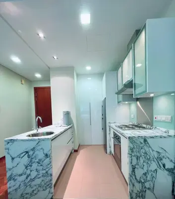 a kitchen with blue and white marble counter tops at Strait Quay Marina Cozy Suite with Bathtub by Uptrend Home Management in Tanjong Tokong