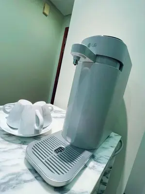 a coffee maker sitting on top of a table at Strait Quay Marina Cozy Suite with Bathtub by Uptrend Home Management in Tanjong Tokong