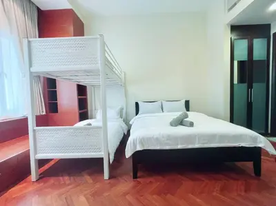 a bedroom with a white bed and a white bunk bed at Strait Quay Marina Cozy Suite with Bathtub by Uptrend Home Management in Tanjong Tokong