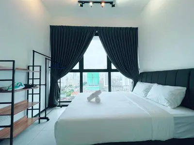 a bedroom with a large bed with a large window at Urban Suite by Uptrend Home Management in Jelutong