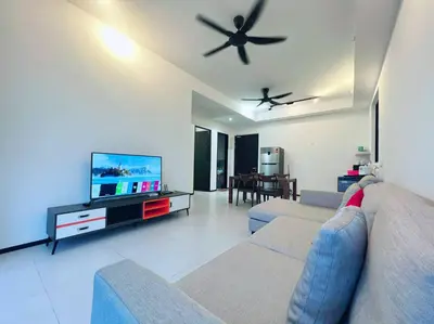 a living room with a couch and a flat screen tv at Urban Suite by Uptrend Home Management in Jelutong