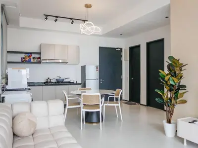 a white living room with a white couch and a table at Urban Suite by Uptrend Home Management in Jelutong
