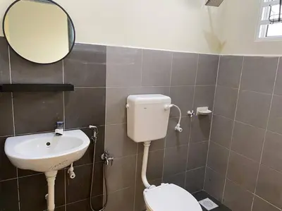 a bathroom with a sink and a toilet and a mirror at Rumah Aidin Homestay in Sitiawan