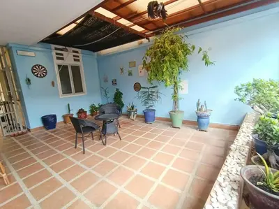 a patio with a table and chairs and potted plants at Cheerful 6BR Town House @ Geortown for 5-14pax by Cohans in George Town