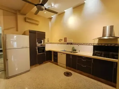 a kitchen with a white refrigerator and a sink at Cheerful 6BR Town House @ Geortown for 5-14pax by Cohans in George Town