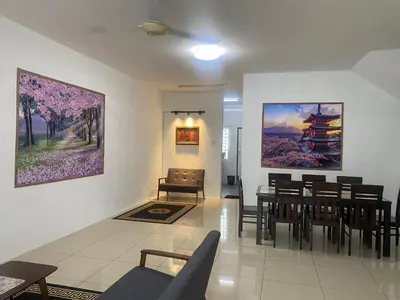 a living room with a dining room table and chairs at Az-zahra Home Stay Kulim Hi-Tech in Kulim