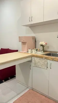 a kitchen with white cabinets and a counter top at SohoMimi Seri Iskandar in Kampung Bota Kiri