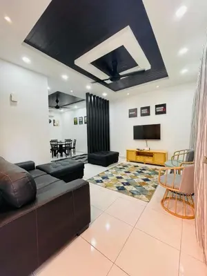 a living room with a couch and a table at Thetamu Homestay مسلم Kepala Batas in Kepala Batas