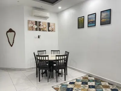 a dining room with a table and four chairs at Thetamu Homestay مسلم Kepala Batas in Kepala Batas