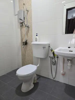 a bathroom with a toilet and a sink at Thetamu Homestay مسلم Kepala Batas in Kepala Batas
