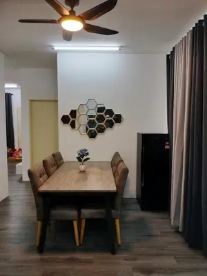 a dining room with a table and chairs and a ceiling fan at AZK HOMESTAY in Sungai Besar