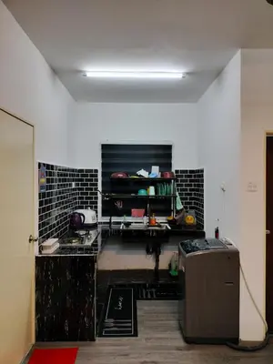 a room with a kitchen with a counter and a refrigerator at AZK HOMESTAY in Sungai Besar