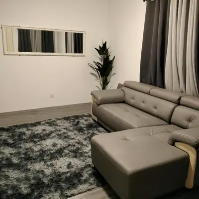a living room with a couch and a rug at AZK HOMESTAY in Sungai Besar