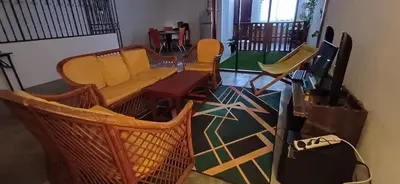 a living room with chairs and a couch at Cozy Nature Homestay - Free Wifi Disney Hotstar ADS in Nibung Tebal