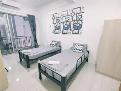 a room with two beds and a picture on the wall at EasyStay Kampar (near UTAR) 5bedrooms 10pax Free WiFi in Kampar