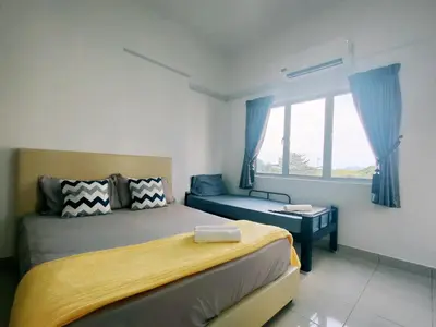 a bedroom with a bed and a couch and a window at EasyStay Kampar (near UTAR) 5bedrooms 10pax Free WiFi in Kampar