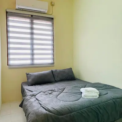 a bed in a room with two towels on it at CYC homestay 18 pax in Kampong Batu Lapan