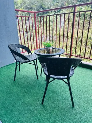 two chairs and a table on a balcony at Adamhawa Homestay Emerald Avenue Brinchang in Brinchang