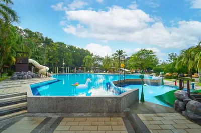 a pool at a theme park with swans in the water at SGI Vacation Club Villa @ Damai Laut Holiday Resort in Lumut