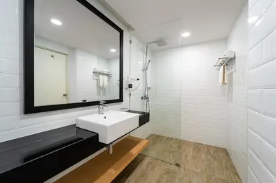a white bathroom with a sink and a mirror at SGI Vacation Club Villa @ Damai Laut Holiday Resort in Lumut