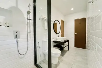 a white bathroom with a toilet and a sink at SGI Vacation Club Villa @ Damai Laut Holiday Resort in Lumut