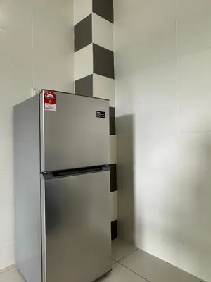 a stainless steel refrigerator in a corner of a room at Sekinchan 2008 Homestay Karaoke BBQ in Sekincan