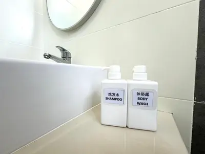 two bottles of detergent sitting on a bathroom sink at Sekinchan 2008 Homestay Karaoke BBQ in Sekincan