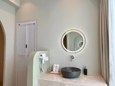 a bathroom with a sink and a mirror at Asimmy Hotel in Kampong Gurun