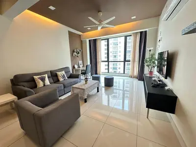 a living room with a couch and a table at JazzA 2R3B Suite Strait Quay Near Stonyhurst School by Homey Planet in Tanjong Tokong