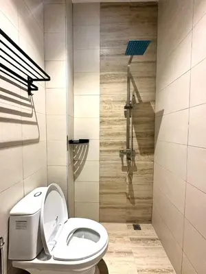a bathroom with a toilet and a shower at Lodge 43 House in George Town