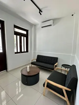 a living room with a couch and a table at Lodge 43 House in George Town