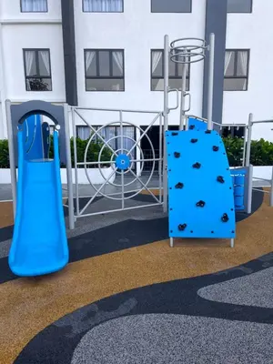 a playground with a blue slide in front of a building at BlissFul Homestay_Horizon@IPOH in Ipoh