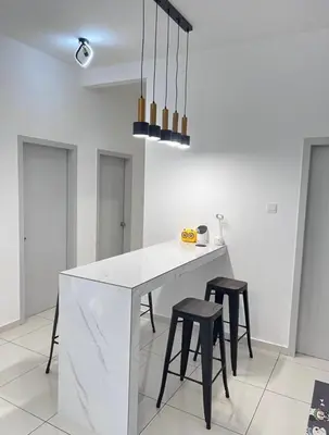a kitchen with a white counter and two stools at BlissFul Homestay_Horizon@IPOH in Ipoh