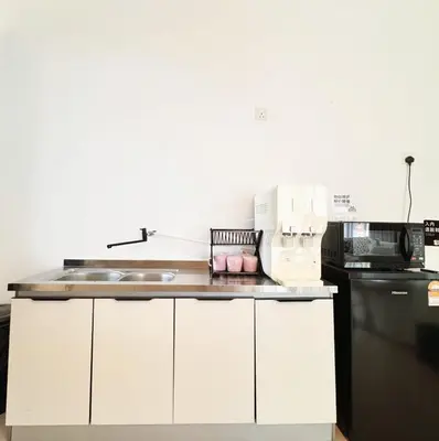 a white kitchen with a sink and a microwave at Georgetown Seaview & Cityview Childroom Infinity pool with Carpark in Jelutong