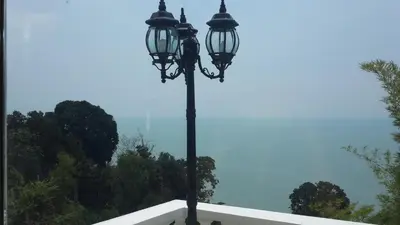 a pole with two lights on top of a building at Tropical Sea View & Sunshine in Batu Ferringhi