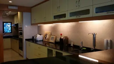 a kitchen with a sink and a counter top at Tropical Sea View & Sunshine in Batu Ferringhi