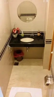 a bathroom with a sink and a mirror at Tropical Sea View & Sunshine in Batu Ferringhi